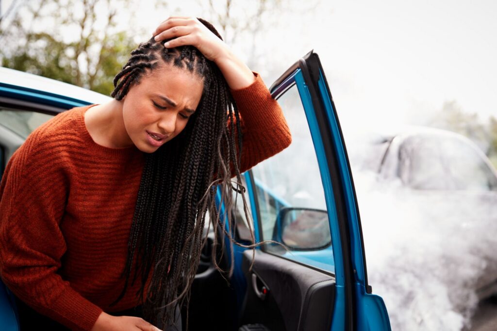 Reckless Driving Vs. Speeding Ticket - Stressed woman driver with papers sitting inside her car