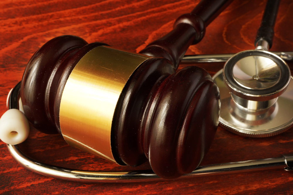 Should I Hire A Lawyer, Or Let The Insurance Handle It? - Gavel and sthethoscope